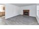 Comfortable living room featuring a brick fireplace and modern flooring, connecting to the kitchen, ideal for gatherings at 1327 Santee St, Charlotte, NC 28208