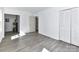 Room featuring grey flooring, closet doors, and utility box at 1327 Santee St, Charlotte, NC 28208