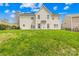 Back exterior of home featuring a large, grassy backyard with space for outdoor activities at 13514 Porter Creek Rd, Charlotte, NC 28262