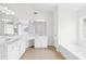 Well-lit bathroom with double sinks, and a separate tub and shower combination at 13514 Porter Creek Rd, Charlotte, NC 28262