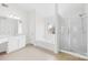 Bright bathroom with a large mirror, tub, and glass-enclosed shower for a modern and relaxing feel at 13514 Porter Creek Rd, Charlotte, NC 28262