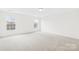 Bright bedroom features two windows with a view and neutral carpeting at 13514 Porter Creek Rd, Charlotte, NC 28262
