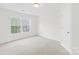 Bright bedroom features a large window with a view and neutral carpeting at 13514 Porter Creek Rd, Charlotte, NC 28262