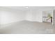 Bright bedroom features neutral carpeting and a doorway to the hallway at 13514 Porter Creek Rd, Charlotte, NC 28262