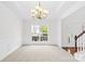 Bright, spacious dining room featuring elegant chandelier, and ample window views at 13514 Porter Creek Rd, Charlotte, NC 28262