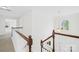 Upstairs hallway features wood railing and a chandelier in the foyer below at 13514 Porter Creek Rd, Charlotte, NC 28262
