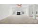 Bright living room featuring a fireplace and large windows at 13514 Porter Creek Rd, Charlotte, NC 28262