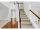 Bright foyer showcasing the staircase with wooden rails and neutral carpet steps at 13514 Porter Creek Rd, Charlotte, NC 28262