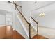 Bright foyer showcasing staircase with wooden rails and hardwood floors, with open rooms at 13514 Porter Creek Rd, Charlotte, NC 28262
