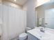 Bright bathroom with a shower over the tub, a white sink, and a vanity mirror at 1814 Shumard Ln, Charlotte, NC 28205