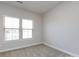 Bright bedroom with two windows that let in lots of natural light and neutral carpet at 1814 Shumard Ln, Charlotte, NC 28205