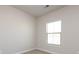This simple bedroom features a neutral palette and a window for natural light at 1814 Shumard Ln, Charlotte, NC 28205