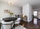 Cozy dining area with modern chandelier, round table, and view to the stairs at 1814 Shumard Ln, Charlotte, NC 28205