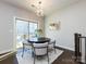 Modern dining area featuring a round table, stylish chairs, and sliding glass door to the outside deck at 1814 Shumard Ln, Charlotte, NC 28205