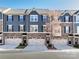 Charming townhome featuring stone accents, gray siding, black shutters, and two-car garage at 1814 Shumard Ln, Charlotte, NC 28205