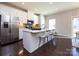 Bright kitchen with stainless steel appliances, white cabinets, and a large center island with seating at 1814 Shumard Ln, Charlotte, NC 28205