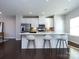Bright kitchen with stainless steel appliances, white cabinets, and a large center island at 1814 Shumard Ln, Charlotte, NC 28205