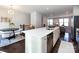 Open concept kitchen with white countertops, stainless steel appliances, and adjacent dining area at 1814 Shumard Ln, Charlotte, NC 28205