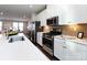 Bright kitchen featuring stainless steel appliances, white cabinetry, and a spacious countertop at 1814 Shumard Ln, Charlotte, NC 28205