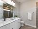 This main bathroom features double sinks, quartz countertops, a glass enclosed shower, and tile flooring at 1814 Shumard Ln, Charlotte, NC 28205