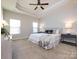 Spacious main bedroom features a tray ceiling, plush carpeting, and windows allowing for ample natural light at 1814 Shumard Ln, Charlotte, NC 28205