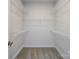 Empty walk-in closet features carpeted floor and shelving for optimal storage at 1814 Shumard Ln, Charlotte, NC 28205