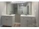 Bathroom with dual vanities, a large mirror, modern fixtures, and a clean design for a functional and stylish space at 18840 Nautical Dr # 57, Cornelius, NC 28031