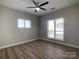 Bright bedroom with wood floors and two windows providing natural light, creating a serene and inviting atmosphere at 18840 Nautical Dr # 57, Cornelius, NC 28031