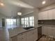 Modern kitchen featuring granite countertops, stainless steel appliances, white cabinets, and a spacious island with a sink at 18840 Nautical Dr # 57, Cornelius, NC 28031
