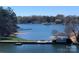 Expansive lake view featuring calm blue water, lakeside gazebo, private dock, and mature trees under a bright blue sky at 18840 Nautical Dr # 57, Cornelius, NC 28031
