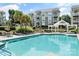 Large outdoor pool with lounge chairs and gazebo, surrounded by landscaping at 18840 Nautical Dr # 57, Cornelius, NC 28031