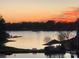 A breathtaking waterfront view at sunset with an ornate gazebo and seating at 18840 Nautical Dr # 57, Cornelius, NC 28031