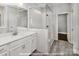 Stylish bathroom featuring a glass shower enclosure, white tile, quartz countertop, and wood-look tile flooring at 19724-A School St, Cornelius, NC 28031