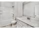 Bright bathroom featuring a shower-tub combo, single vanity, and white fixtures with ample natural lighting at 19724-A School St, Cornelius, NC 28031