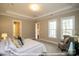 Main bedroom with a large bed and two big windows providing lots of natural light at 19724-A School St, Cornelius, NC 28031