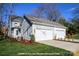 View of a house with an attached three-car garage and light blue siding at 19724-A School St, Cornelius, NC 28031
