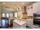 Bright kitchen boasts white cabinets, stainless steel appliances, pendant lighting and center island at 19724-A School St, Cornelius, NC 28031