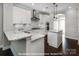 Well-lit kitchen with white cabinets, granite countertops, and stainless steel appliances at 19724-A School St, Cornelius, NC 28031