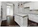 Open concept kitchen with a center island, stainless steel appliances, and white cabinets at 19724-A School St, Cornelius, NC 28031