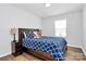 Bedroom features wood floors, a teddy bear on the bed, and side tables with lamps at 2707 Aubrey St, Monroe, NC 28110