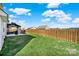 Large backyard with a well-maintained lawn, patio, fence, and outdoor grill at 311 Glenn Allen Rd, Mooresville, NC 28115