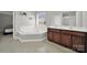 Bathroom showcasing a soaking tub, dual sink vanity, and a window for natural light, perfect for relaxation at 311 Glenn Allen Rd, Mooresville, NC 28115