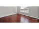 Cozy bedroom with rich hardwood flooring, and ample light making it a simple and comfortable living space at 311 Glenn Allen Rd, Mooresville, NC 28115