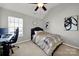 Cozy bedroom with a ceiling fan, window, and neutral colors offering a comfortable and serene living space at 311 Glenn Allen Rd, Mooresville, NC 28115