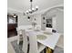 Elegant dining room with a modern white table, complemented by stylish chairs and an open view into the kitchen at 311 Glenn Allen Rd, Mooresville, NC 28115