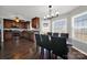 Open layout kitchen with dark wood cabinets, stainless steel appliances, and an adjacent dining area bathed in natural light at 311 Glenn Allen Rd, Mooresville, NC 28115