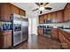 Spacious kitchen with stainless steel appliances, sleek dark countertops, and dark wood flooring, seamlessly blending style and functionality at 311 Glenn Allen Rd, Mooresville, NC 28115