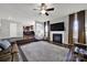 Spacious living room with a fireplace, creating a cozy and inviting atmosphere with hardwood floors and natural lighting at 311 Glenn Allen Rd, Mooresville, NC 28115