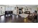 Open-concept living space with a combined dining and living area, featuring hardwood floors and a cozy fireplace at 311 Glenn Allen Rd, Mooresville, NC 28115