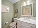 Cozy bathroom with framed art and a modern vanity with marble countertops at 3229 Leicester Dr, Matthews, NC 28104